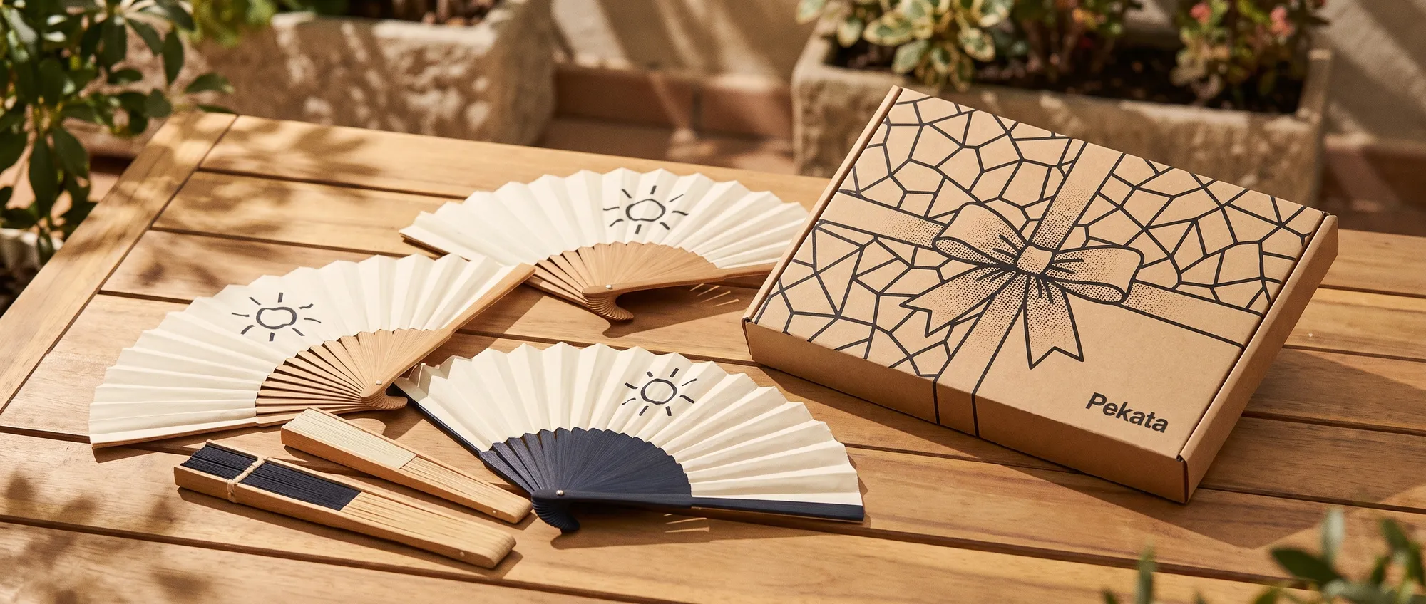 Foldable bamboo fans and cardboard fans customised with a company's logo